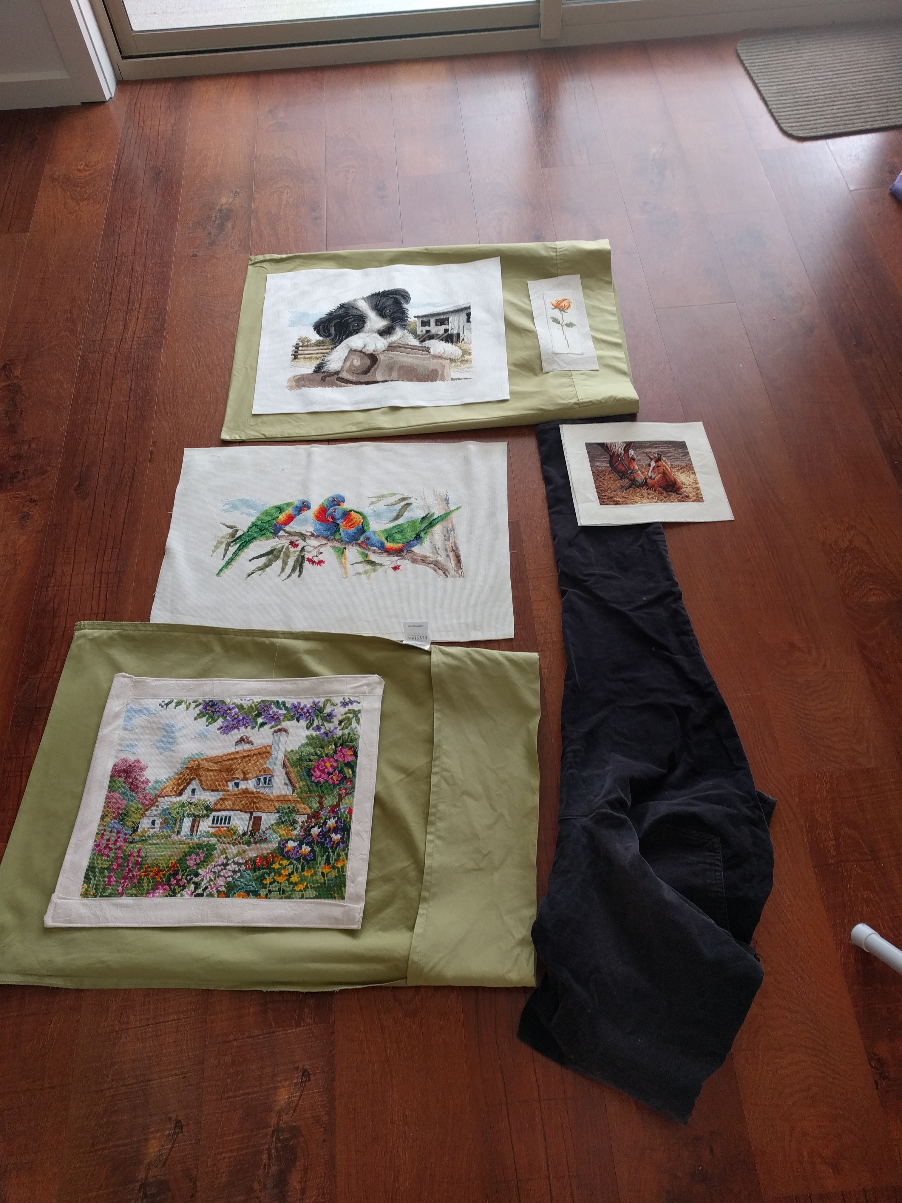 Image shows how the navy blue and lime green looks as the border and connecting pieces for the cross stitch pictures.