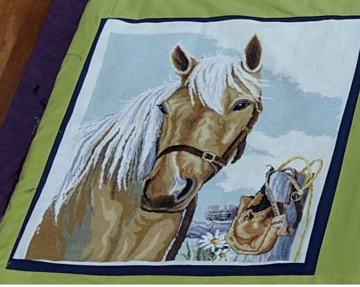 Completed Palamino. I have used this as part of a country/outback/Australiana themed  quilt. I've used a navy blue trim around it with lime green or avacado green fabric to connect it to other cross stitch pictures.