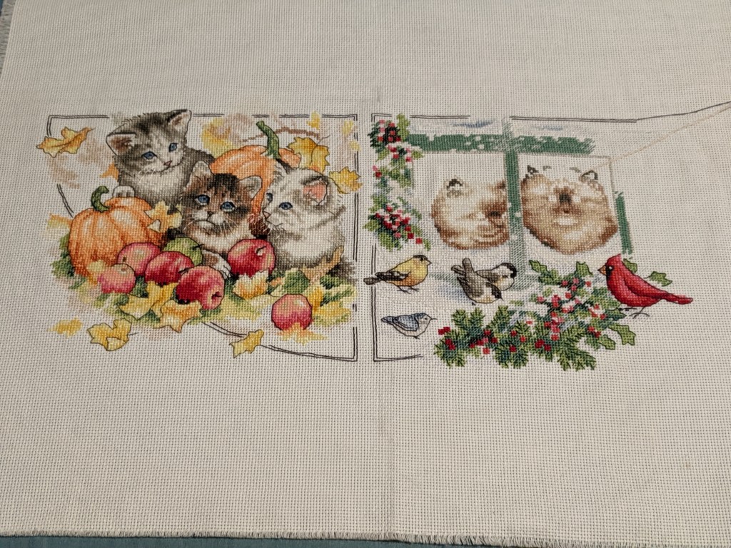 Autumn kittens are complete on the left hand side and the winter kittens are making progress. At the moment it's quite clear that there will be two kittens looking out the window because of the snow. They are framed by the window, holly and some birds.